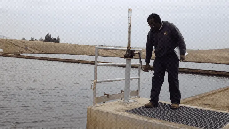The lead engineer on the Harris Reservoir, Carmelo (right), descends into the reservoir during its warranty inspection. Westlake tanks are typically nicknamed after their design engineers, so this one informally carries his name. - 2011